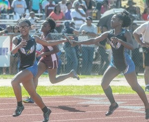 Oxford’s Jakiara Dunn and Kadijah Ramsey hand off the baton during the 4x200-meter relay Saturday. The Lady Chargers won the event.