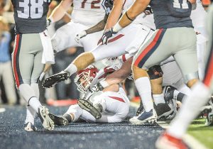 Arkansas quarterback Brandon Allen (10) dives in to the end zone for a two-point conversion during overtime to deliver a stunning win for the Razorbacks last year. (Bruce Newman)