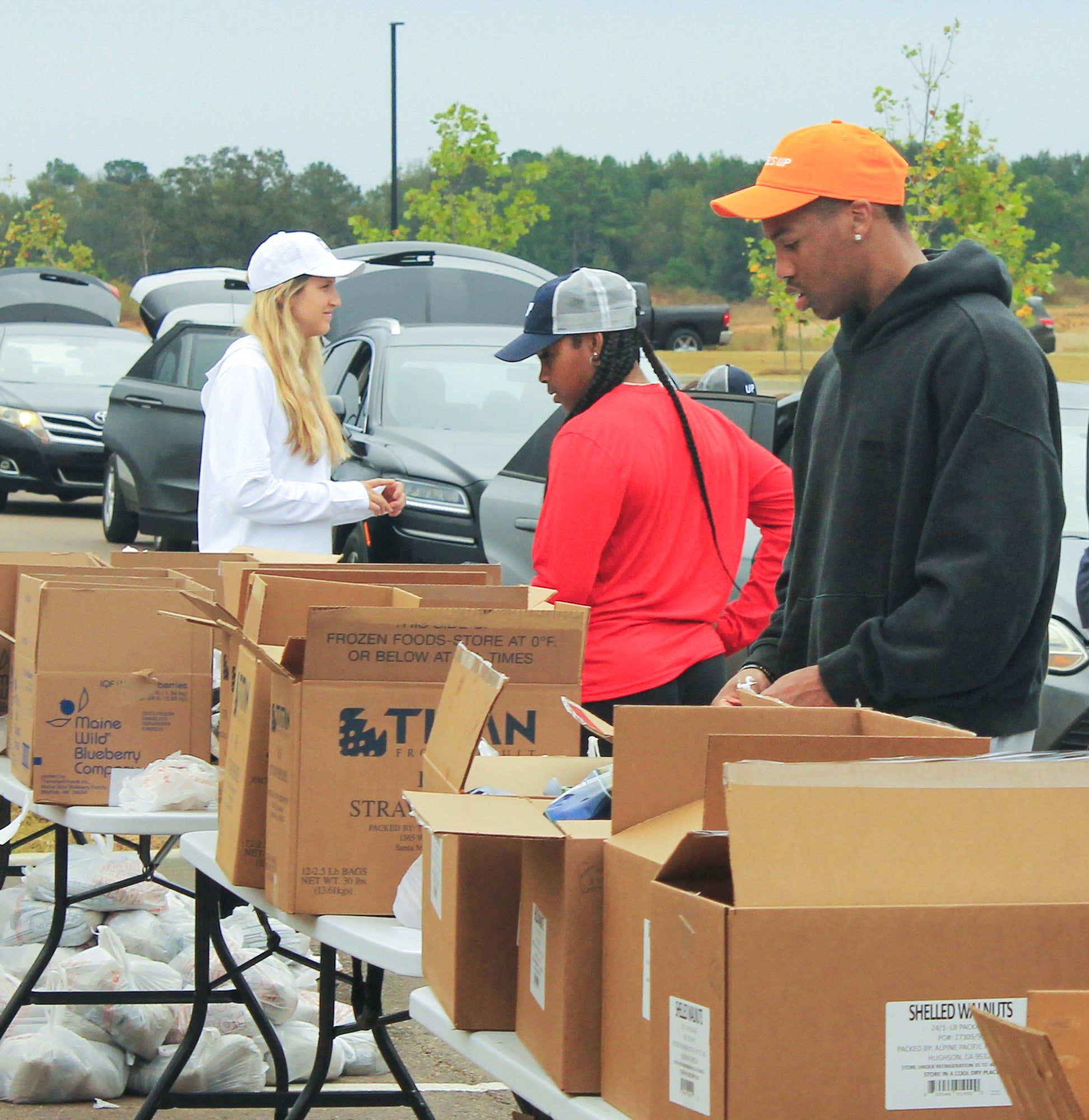 Ole Miss athletes partner with Wheels Up, Grove Collective, and Brandr Group to aid Oxford families through a service day at Mid-South Food Bank.