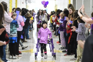 Lafayette Elementary 5th grader Everly Taylor, who is battling brain cancer, walked through the school halls to the cheers of fellow students during a parade held in her honor before she left for surgery on Monday, Dec. 4. (©Bruce Newman)